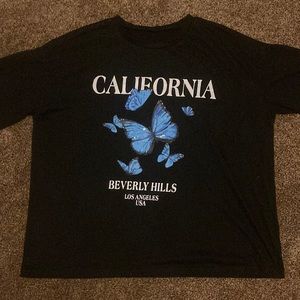 Black over sized T-shirt with blue butterfly’s from SHIEN.